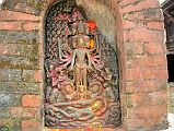 Kathmandu Changu Narayan 10-1 10 Headed And 10-Armed Vishnu Stone Statue With Another Vishnu Below Lying On Serpent Ananta A small black slab from 5C or 6C at Changu Narayan has a 10-headed and 10-armed standing Vishnu, with another Vishnu reclining on the serpent Ananta below. The scenes are divided into three sections  the heavens, the world of men, and the underworld below.